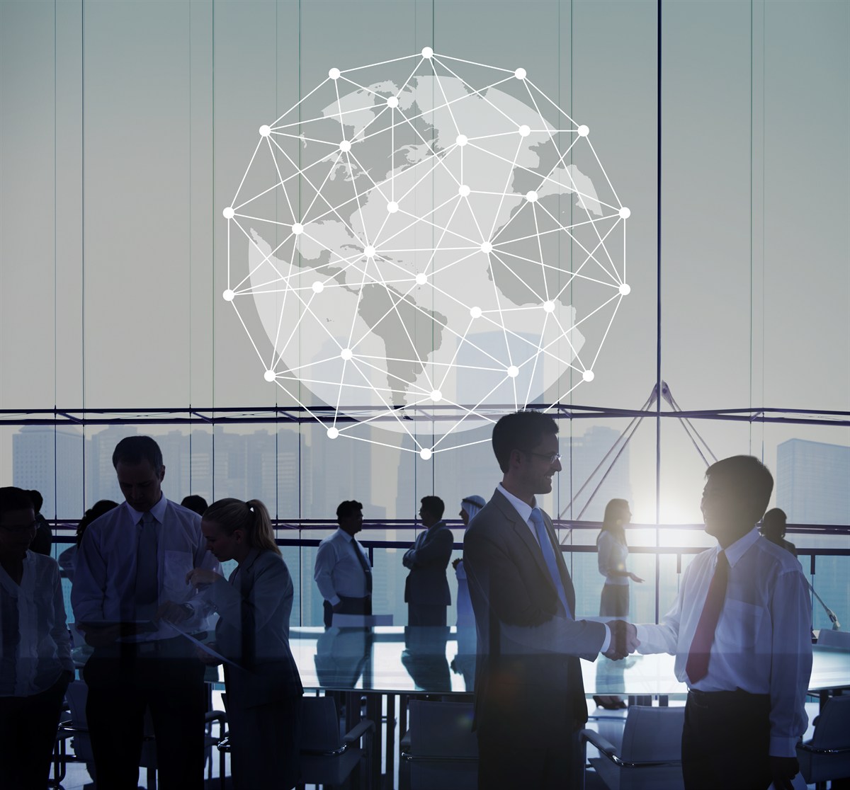 Colleagues shaking hands in front of a connected world map