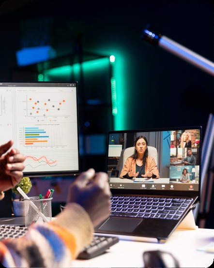 Learner reviewing charts during a video class on a laptop