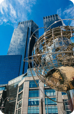 Columbus Circle globe in front of office towers