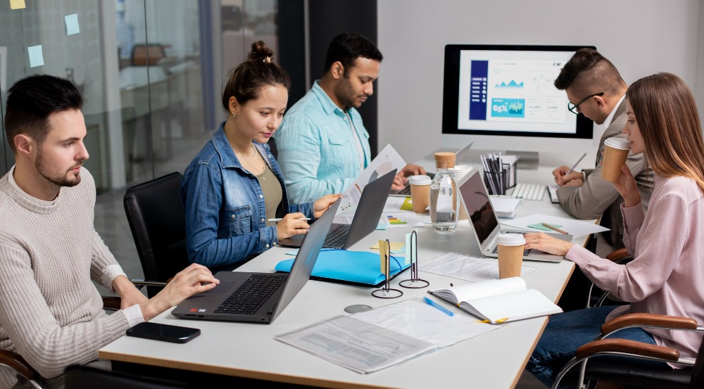 Teams collaborating around workforce and operations dashboards